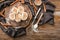 Wooden board with uncooked cinnamon rolls on kitchen table