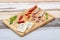 Wooden board with yummy appetizers: sausages, blue cheese, hot peppers
