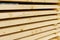 Wooden boards, bars close-up in a lumber warehouse.