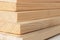 Wooden boards on white in a woodworking industry. stacks with pine lumber. folded edge board. timber for construction