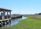 A wooden boardwalk going through marsh wetlands