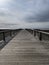 Wooden boardwalk going out to ocean