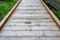 Wooden boardwalk, an invitation to explore a woodland garden