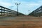 A wooden boardwalk with lights, wooden deck with railings