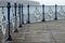 Wooden boardwalk and metal railings at Swanage Pier Dorset UK, photographed on a cold, windy day.