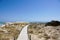 Wooden boardwalk and turquoise water at the Illetes beach in Formentera. Balearic Islands. Spain