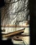 Wooden boat abandoned at shore viewed through a hole in the wall