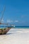 Wooden boat at the beach on Zanzibar Island with stunning turquoise water