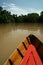 Wooden boat on brown river