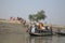 Wooden boat crosses the Ganges River in Gosaba, West Bengal, India