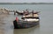 Wooden boat crosses the Ganges River in Gosaba, West Bengal, India