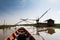 Wooden boat cruising along the lake passing the fisherman\'s house