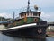 A wooden boat is at the dock in Gibsons BC on the Sunshine Coast