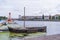 Wooden boat and a floating lighthouse stand in the water