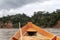 Wooden boat front and green jungle landscape, sailing in the muddy water of the Beni river, Amazonian rainforest, Bolivia