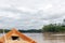 Wooden boat front and green jungle landscape, sailing in the muddy water of the Beni river, Amazonian rainforest, Bolivia