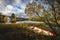 Wooden boat by the lake shore, Norway, beautiful autumn time, calm water