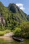 Wooden boat moored on the bank of a river in a very quiet place under the mountains, Vang Vieng, Laos