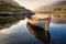 Wooden boat on mountain lake, idyllic landscape with water and forest, generative AI