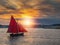 Wooden boat with red color sail going into harbor. Galway city, Ireland. Popular local type boat called Galway hooker. Sport and