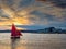 Wooden boat with red color sail going into harbor. Galway city, Ireland. Popular local type boat called Galway hooker. Sport and