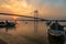 Wooden boat on river Hooghly at sunset with Vidyasagar bridge at the backdrop.