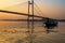 Wooden boat on river Hooghly at twilight near Vidyasagar bridge setu, Kolkata, India.