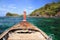 Wooden boat sailing on crystal sea to beautiful island near Koh Lipe