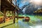 Wooden boathouse and boats on the alpine lake, Dolomites, Italy