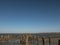 Wooden bollards in the sand against the estuary and blue sky. kuyalnitsky estuary