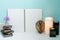 Wooden books, flower, wooden Bali mask, warm light candle and cl