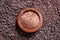 Wooden bowl on black salt background