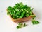 Wooden bowl with corn salad leaves, lamb`s lettuce on white wood