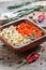 Wooden bowl with dried carrots and celery root.