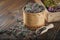 Wooden bowl of dry wild Marjoram or Origanum vulgare plants, wooden crate of medicinal herbs.