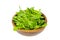 Wooden bowl with fresh green leaves of cornsalad
