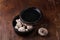 Wooden bowl of fresh raw champignon mushrooms on kitchen table. Autumn harvest, seasonal jrganic vegan food, healhty eating habits