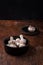 Wooden bowl of fresh raw champignon mushrooms on kitchen table. Autumn harvest, seasonal jrganic vegan food, healhty eating habits