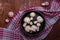 Wooden bowl of fresh raw champignon mushrooms on red kitchen towel. Autumn harvest, seasonal jrganic vegan food, healhty eating