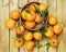 Wooden bowl with fresh tangerine mandarins fruit i