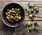 Wooden bowl full of olives.