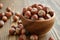Wooden bowl of hazelnuts close up
