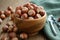 Wooden bowl of hazelnuts and nutcracker on table