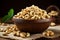 Wooden bowl holds cashew nuts on rustic burlap cloth backdrop