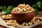 Wooden bowl holds cashew nuts on rustic burlap cloth backdrop