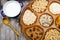 Wooden bowl with mixed breakfast cereals and blue bowl with fresh milk