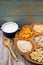 Wooden bowl with mixed breakfast cereals and blue bowl with fresh milk