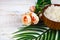 Wooden bowl with sea salt, rose and palm leaf