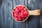 Wooden bowl with summer raspberries