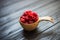 Wooden bowl with summer raspberries on table